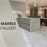 How are marble slabs installed?